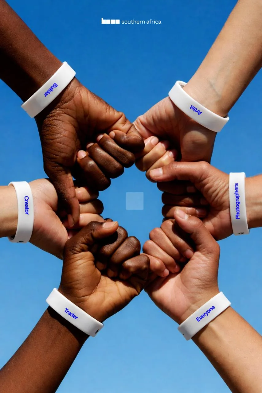 Hands wearing Base wristbands brought together