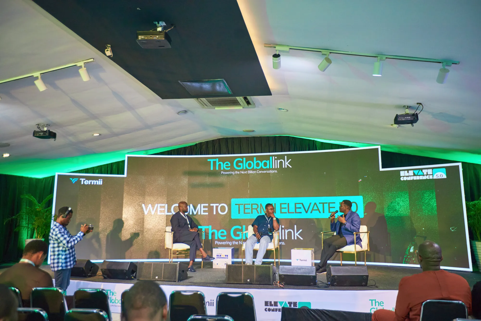 The Termii Elevate stage during a session, with “Welcome to Termii Elevate” on the screen behind three speakers